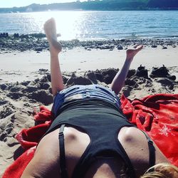 Low section of people relaxing on beach