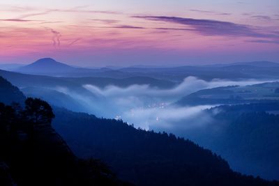 Scenic view of silhouette mountains against sky at sunset