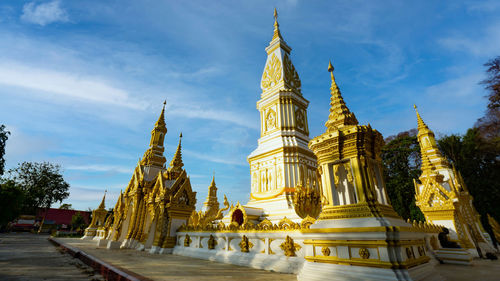 Temple by building against sky