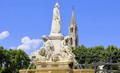 Low angle view of statue against blue sky