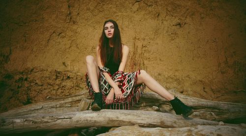 Young woman sitting outdoors