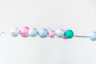 Close-up of multi colored candies against white background