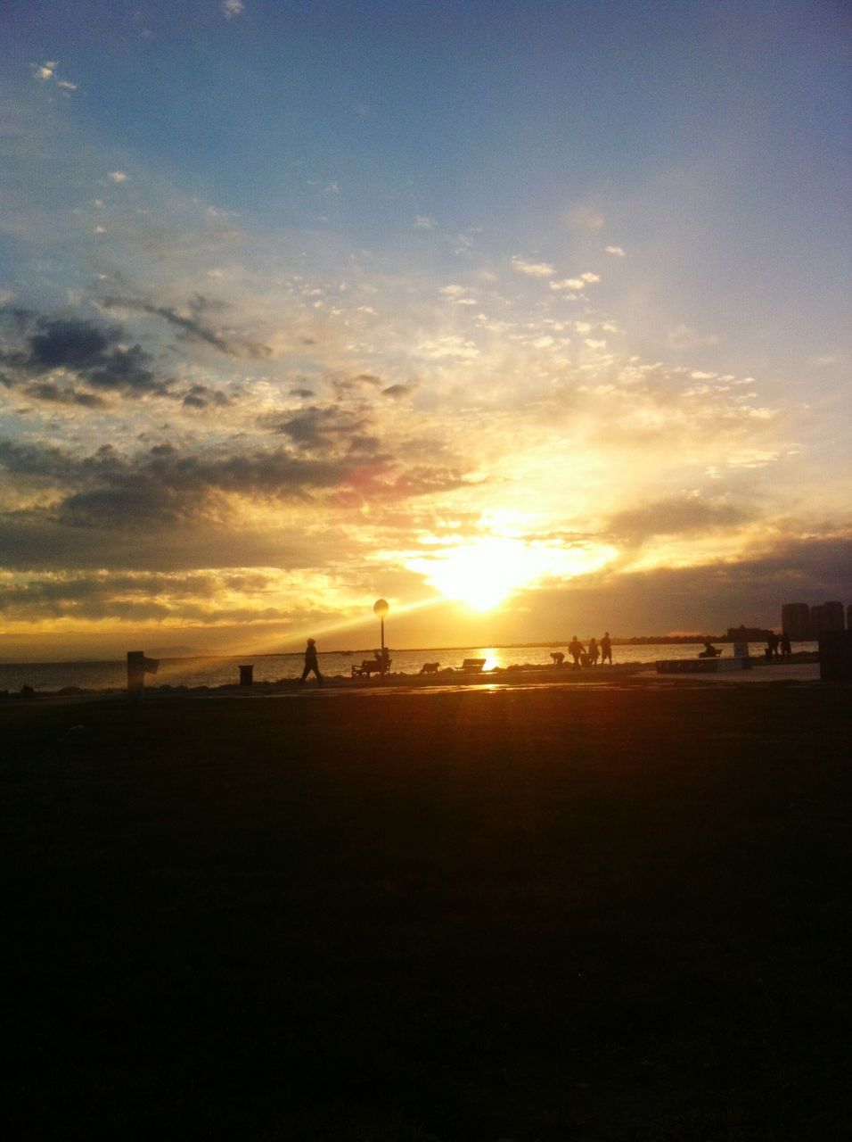 sunset, sea, scenics, sun, beach, water, silhouette, tranquil scene, sky, beauty in nature, tranquility, orange color, horizon over water, shore, idyllic, nature, cloud - sky, sunlight, incidental people, sunbeam