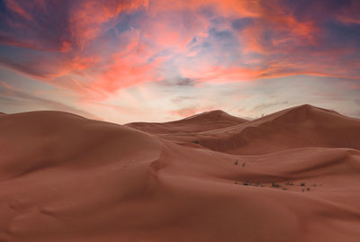 Scenic view of desert against sky during sunset