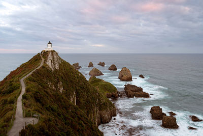 Scenic view of rocks in sea against sky