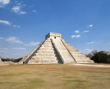 Chichen itza against blue sky during sunny day