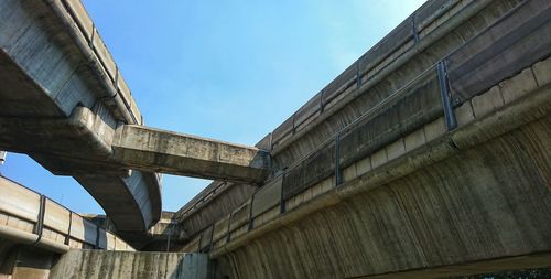 Low angle view of bridge against sky in city