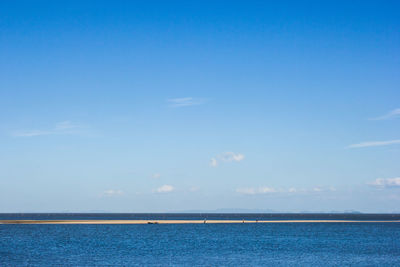 Scenic view of sea against blue sky