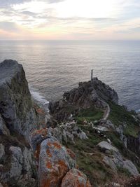 Scenic view of rocks in sea against sky