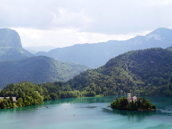 Scenic view of calm lake against mountain range