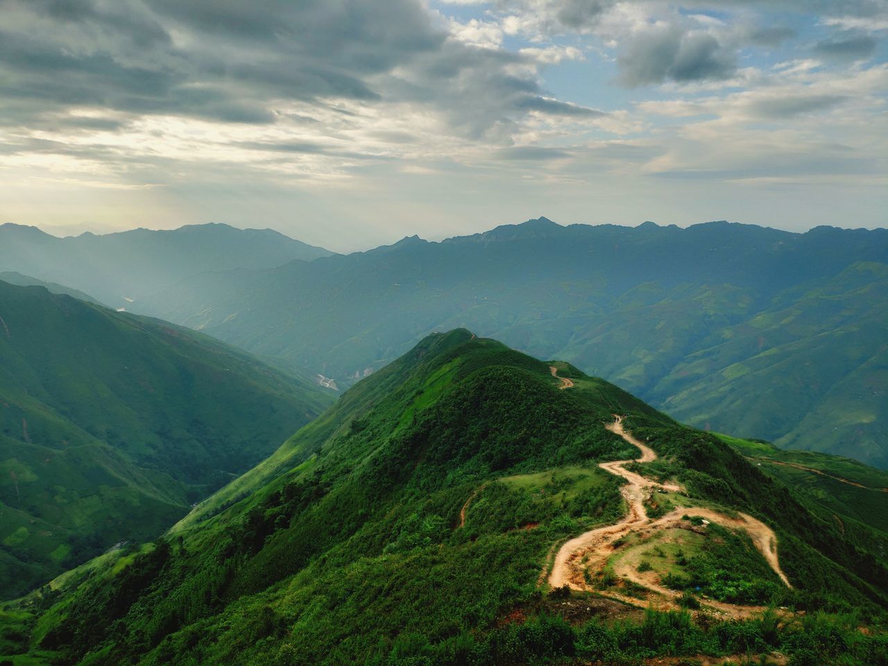 mountain, scenics - nature, beauty in nature, tranquil scene, cloud - sky, sky, tranquility, environment, mountain range, landscape, non-urban scene, idyllic, green color, nature, no people, plant, day, remote, land, lush foliage, outdoors, mountain peak, rolling landscape, mountain ridge