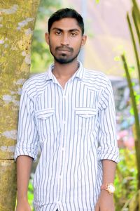 Portrait of young man standing outdoors