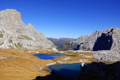 Scenic view of mountains against clear blue sky