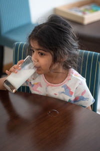 Close-up of girl drinking milk