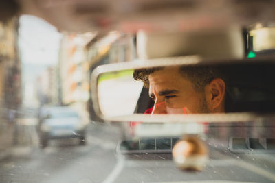 Portrait of young man in car