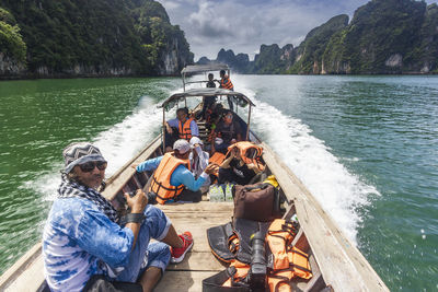 People sitting on boat in sea