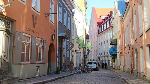 Footpath amidst buildings in city