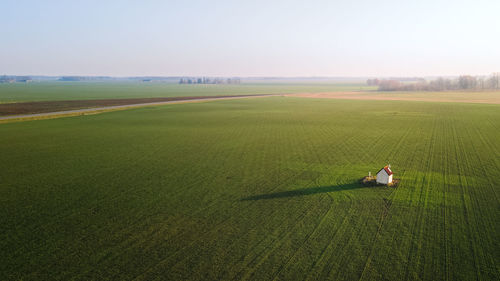 Cabin in a sunlit field 