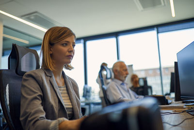 Businesswoman using computer in office