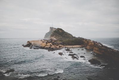 Scenic view of rock formation and sea against sky