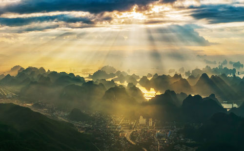 Sunlight streaming through clouds on halong bay during sunrise