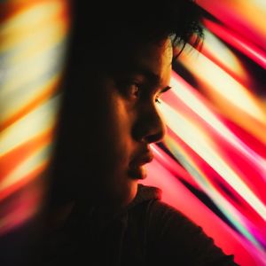 Close-up portrait of young man looking away