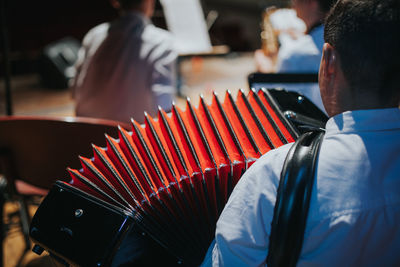 Rear view of musician playing accordion