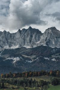 Scenic view of mountains against cloudy sky