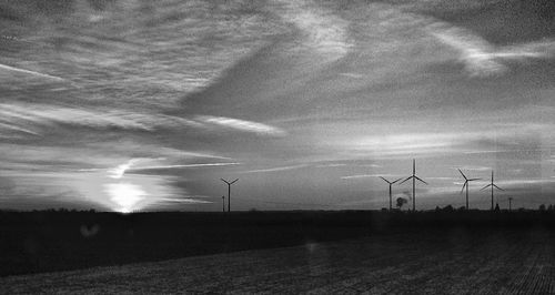 View of wind turbines on landscape against the sky