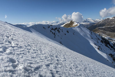 Scenic view of snow covered mountains against sky