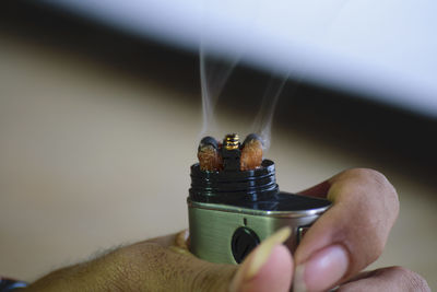 Close-up of woman holding electronic cigarette