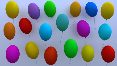 Close-up of multi colored balloons against wall