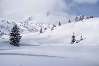 Scenic view of snow covered mountains against sky