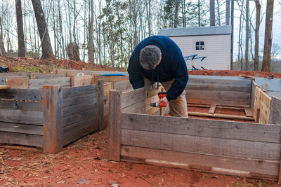 Rear view of man working at farm