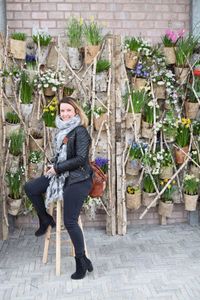 Woman standing by plants