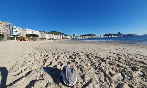 Scenic view of beach against clear blue sky