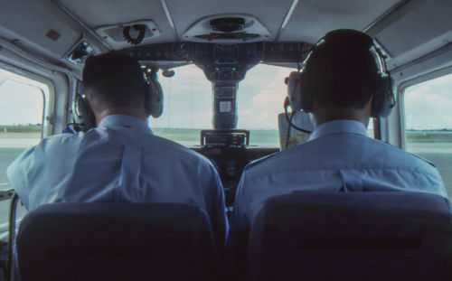 Rear view of people traveling in train