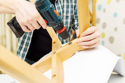 Cropped hand of man working in workshop