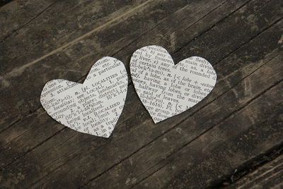 Close-up of heart shape paper cutouts on wooden table