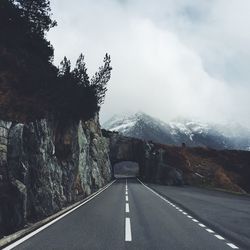 Empty road leading towards tunnel