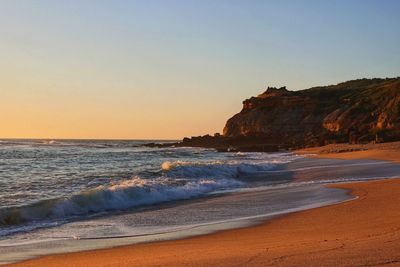 Scenic view of sea against clear sky during sunset
