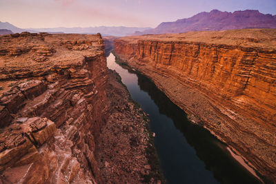 High angle view of river amidst mountains during sunset