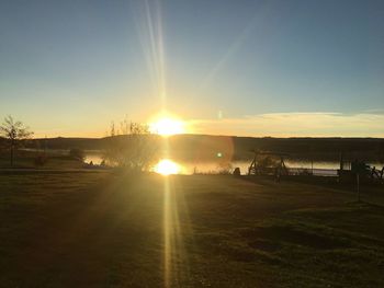 Scenic view of field against sky during sunset