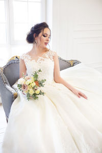 Beautiful bride with bouquet during wedding ceremony