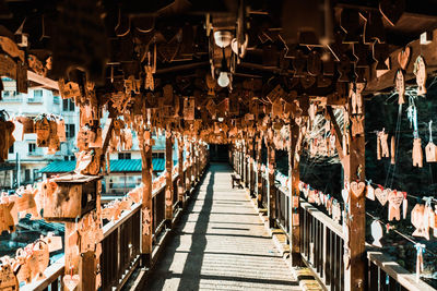 View of prayer blocks hanging on bridge against building