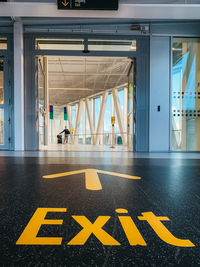 Low angle view of arrow sign at airport