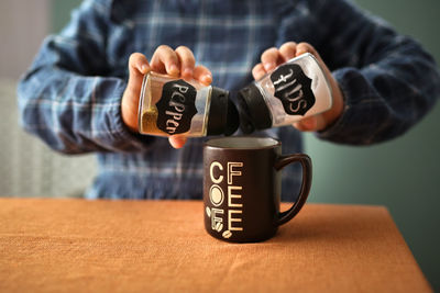 Midsection of man holding bitcoin