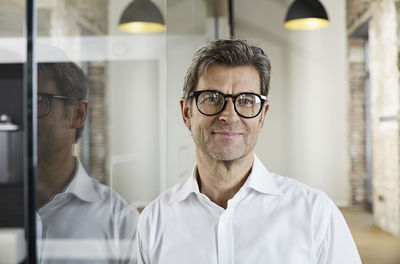 Portrait of smiling businessman wearing glasses
