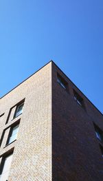 Low angle view of building against clear blue sky