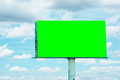 Low angle view of road sign against sky